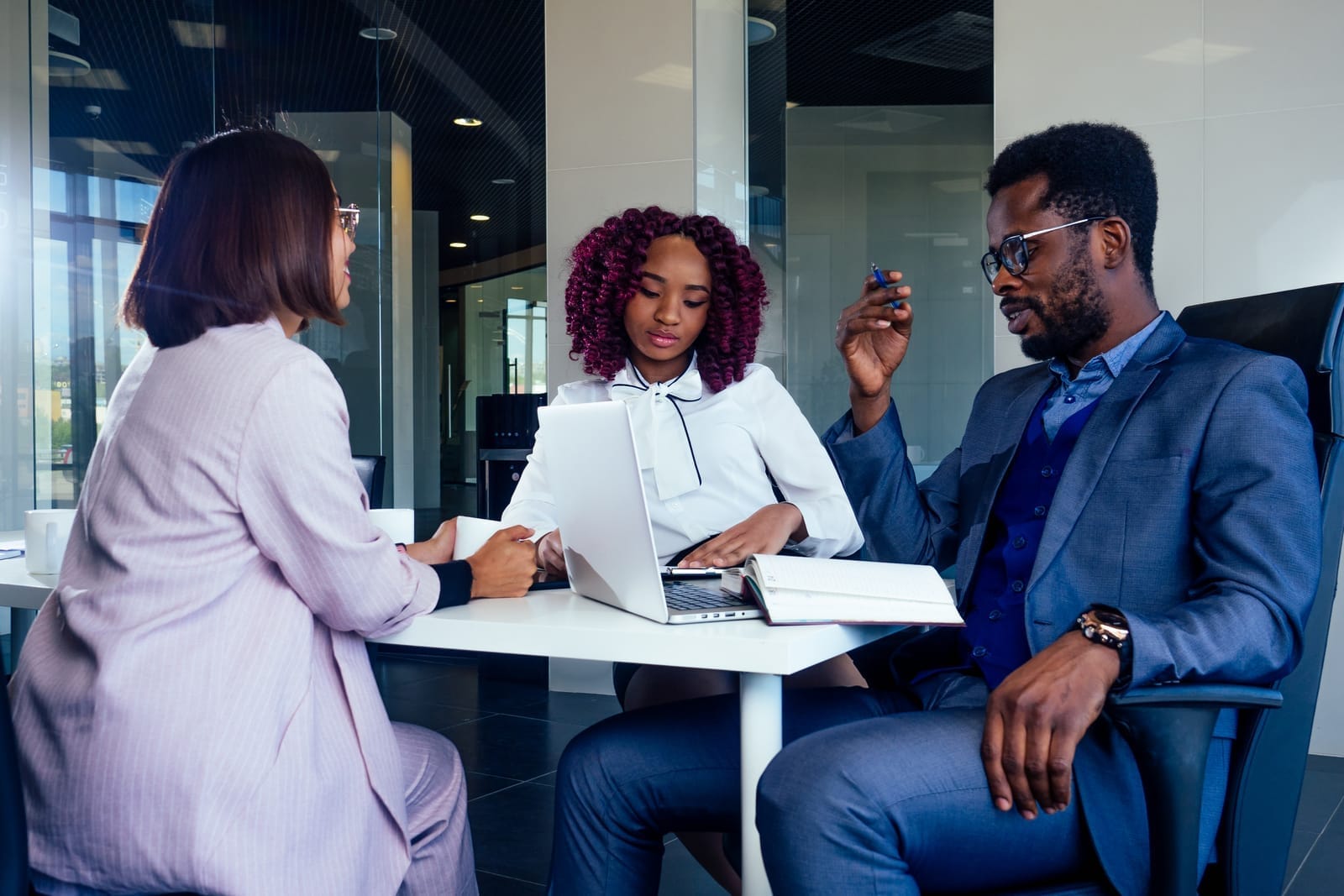 Business partners discussing financing around a laptop